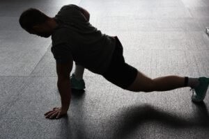 A healthy man is exercising in a modern gym to improve fitness and overall health.