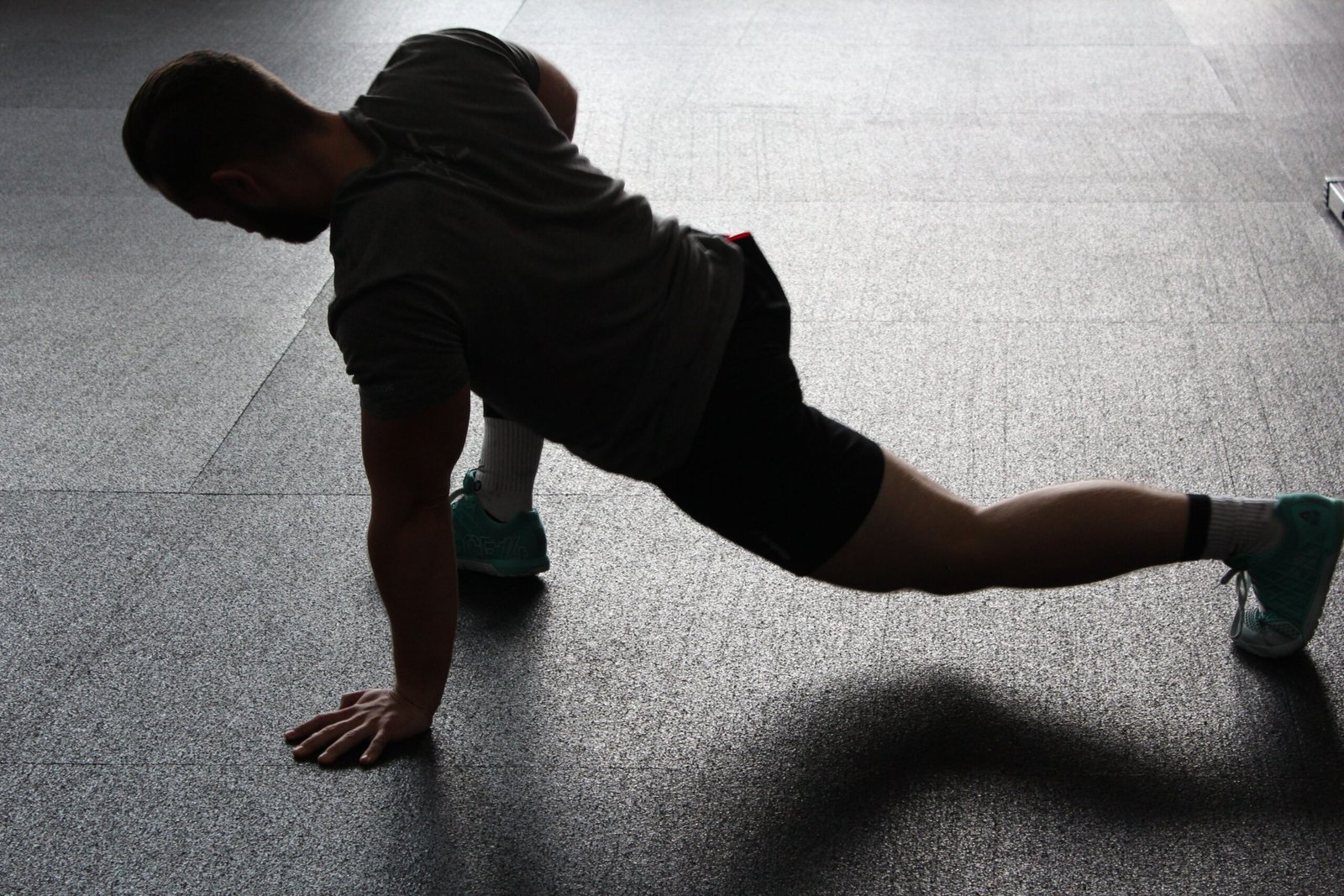A healthy man is exercising in a modern gym to improve fitness and overall health.