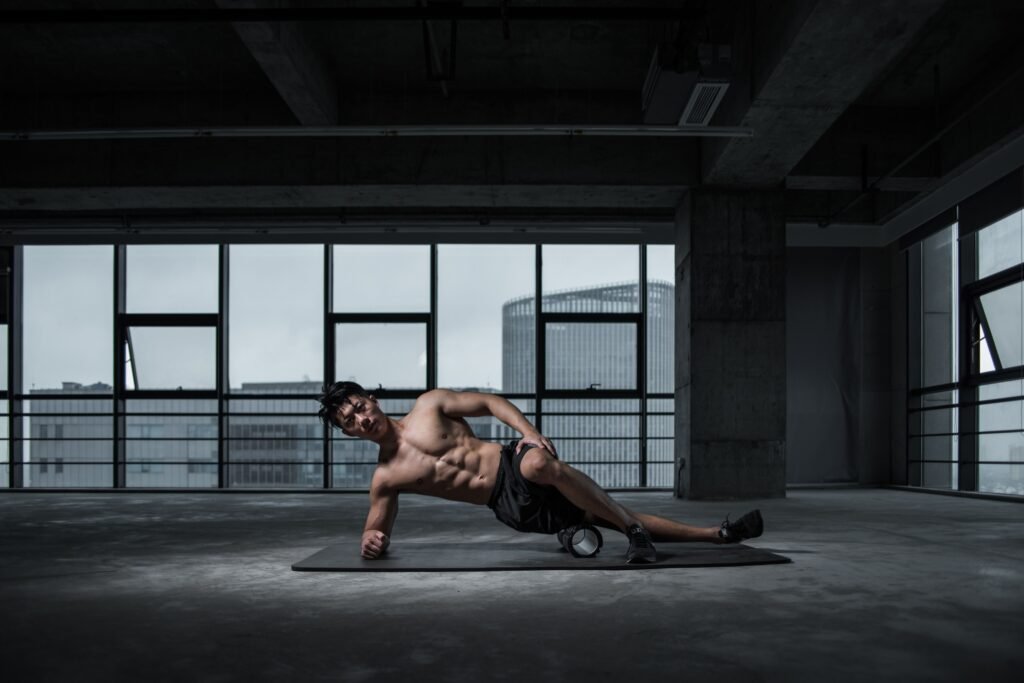 Athlete sleeping peacefully after an intense gym workout with dumbbells beside the bed.