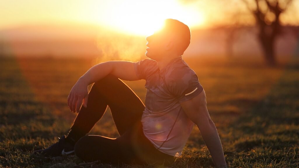 People jogging together in a green park at sunrise, representing healthy living and longevity.