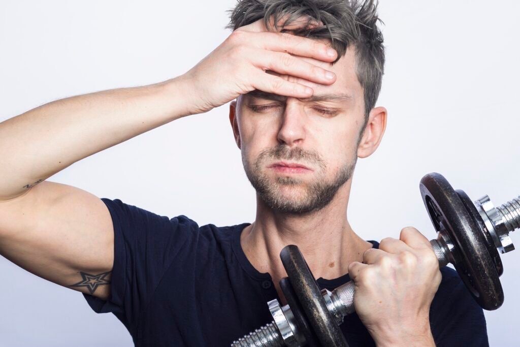 Personal trainer encouraging a client during a strength-training session.