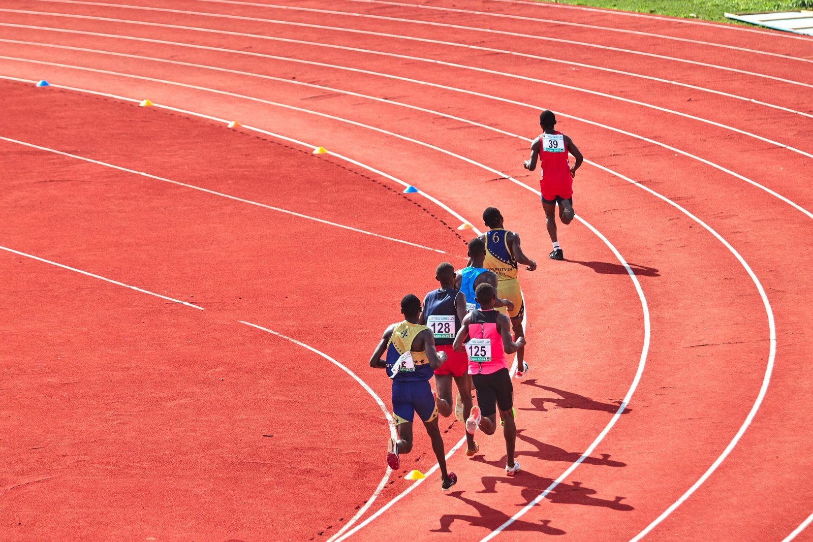 Track runners competing in a sprint race on the athletics track at Paloma Mizuho Stadium