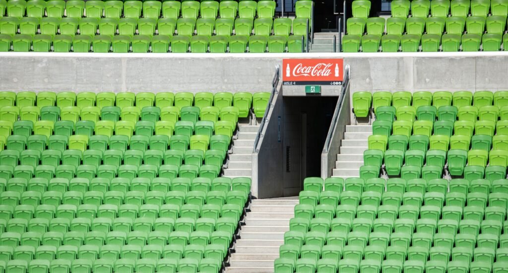 Packed crowd cheering at Coca-Cola Arena for Dubai Basketball EuroLeague debut