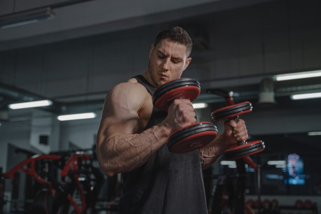 The trainer logs workout weights and repetitions on a clipboard to track progressive overload consistency. 