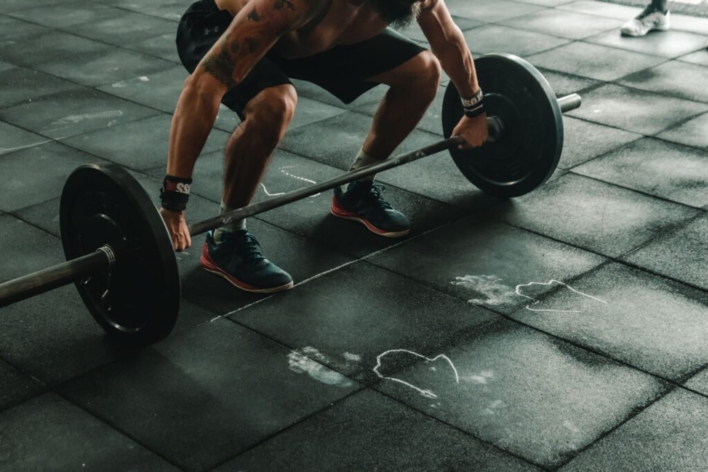 Athlete performing a heavy barbell back squat to build muscle and increase resting metabolic rate. 