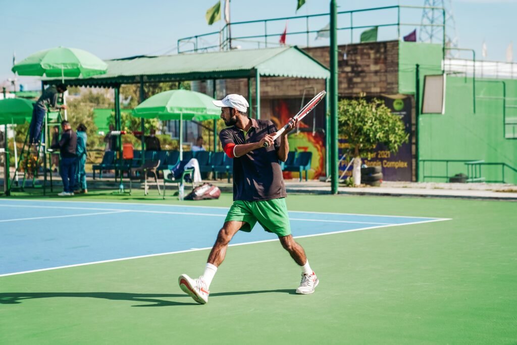 Professional tennis player serving on the pristine grass court during a Wimbledon tournament match 