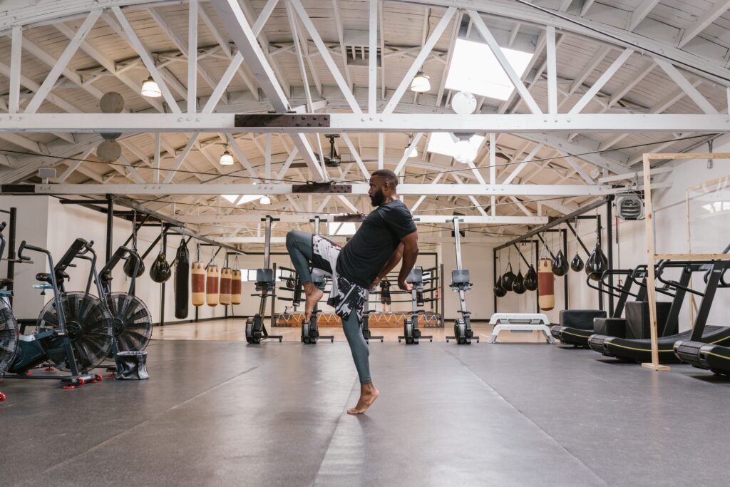 Modern interior of a French salle de sport showing cardio machines and strength training areas.