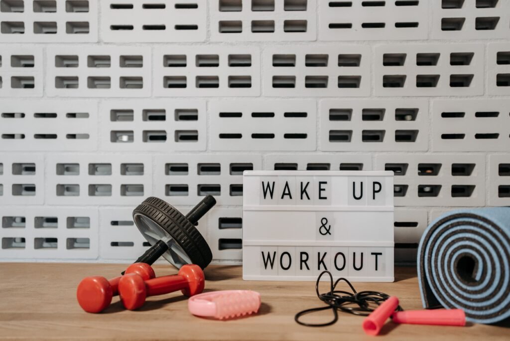 A motivated athlete checking a fitness journal after completing a workout in a bright modern gym.