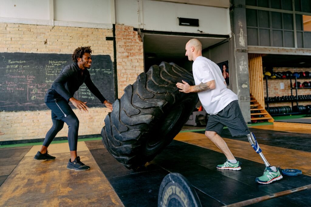 A group participating in an energetic high-intensity interval training class inside a modern boutique fitness studio.