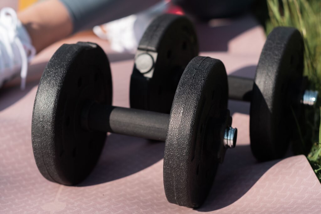 Athlete holding a cast-iron kettlebell in a rack position during a workout session. 