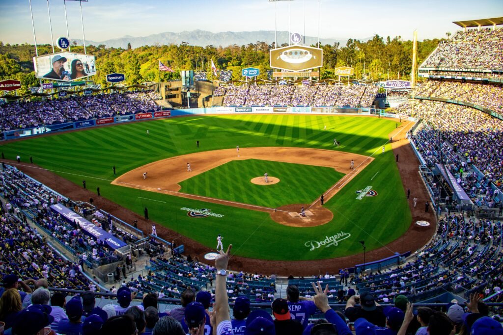 MLB Pennant Race: Teams Push for October Postseason Stadium scoreboard displaying tight division standings during the August MLB pennant chase.