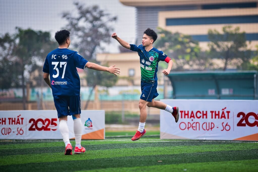 Asian national football team players competing in a group stage match at Toyota Stadium. 