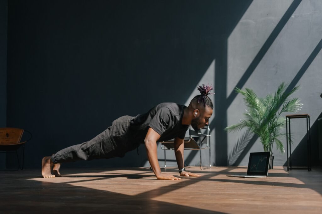 Wall-mounted smart home gym utilizing digital resistance cables during an indoor strength workout. 