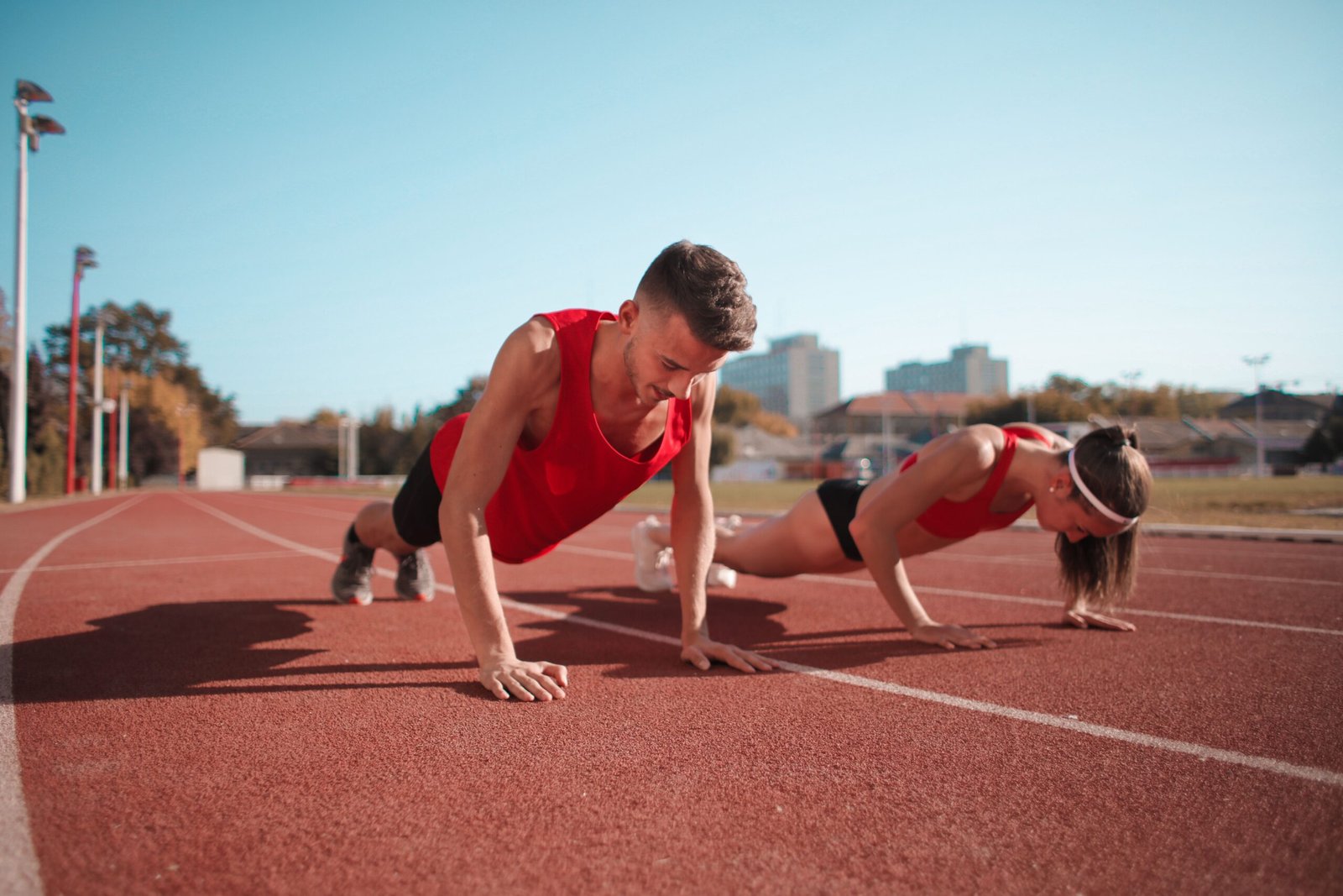 Young people exercising outdoors to improve fitness and maintain a healthy lifestyle.